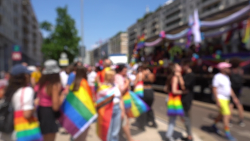 Europe, Italy ,Milan July 2023 - Defocused Crowd of people , Gay Pride -  LGBT equality march, pride parade. Young people with rainbows are walking the streets, manifestation of free sex and equality