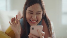 Asia Gen Z single woman sit at home sofa couch read and look at man boy photo post on phone. Relax smile choose lover enjoy play right swipe on tinder app to find love couple in fun match flirt chat. - Powered by Shutterstock - Get 15% off with code: PIKWIZARD15