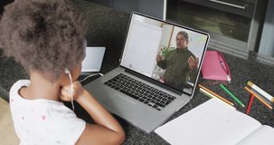 African american girl using laptop for video call, with male teacher on screen. Communication technology and online education, digital composite video.