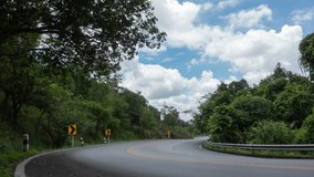 White clouds on blue sky background over doi suthep road. Ultra HD 4k time lapse footage.