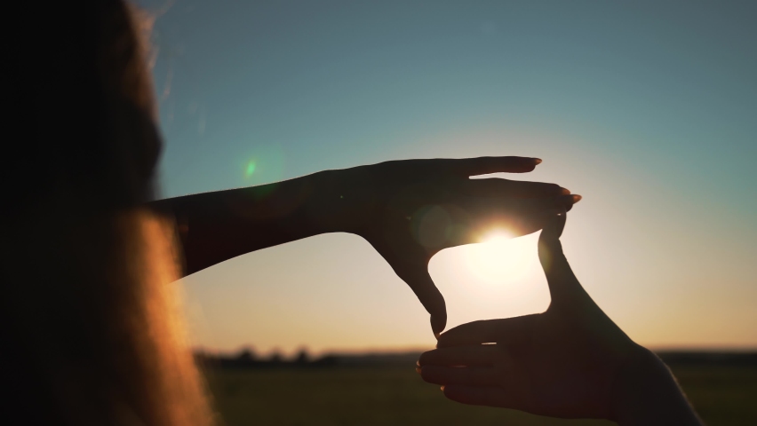 Business strategy. Girl folded her hands in frame at sunset. Silhouette of girl in natural park. Fingers at sunset. Work planning. Girl in field folded her hands into frame. Business planning concept. | Shutterstock HD Video #1092010229