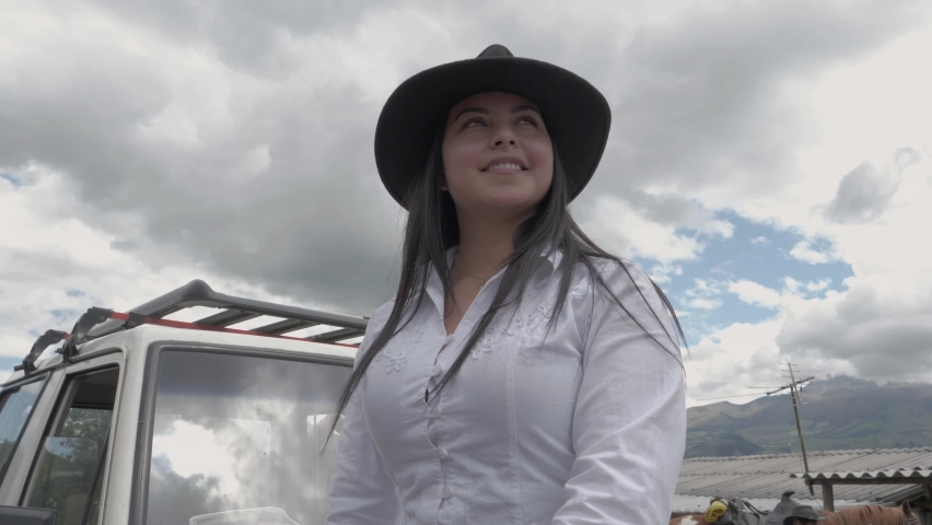 Beautiful and smiling cowgirl on a ranch.