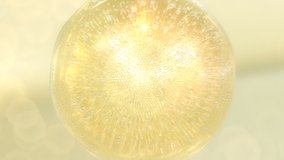 Golden cosmetic serum with floating collagen bubbles and glowing particles in soft light. Skincare, hydration, and vitamin energy concept for beauty and wellness design. - Powered by Shutterstock - Get 15% off with code: PIKWIZARD15