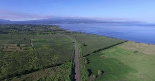 MXGP Circuit Samota in Sumbawa Island. Aerial panoramic View of a scenic Highway surrounded green field Landscape during a summer morning