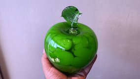 Macro Detail shot 4K video abstract pastel background image of hand made green glass apple buying.  - Powered by Shutterstock - Get 15% off with code: PIKWIZARD15