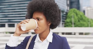 Animation of data processing and world map over african american woman drinking coffee. Global business and digital interface concept digitally generated video.