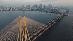 Cinematic Aerial view of vehicles Passing over Bandra Worli Sea Link in Mumbai, India. Flying over the Arabian Sea. Birds Eye View 4K Cinematic Drone Footage