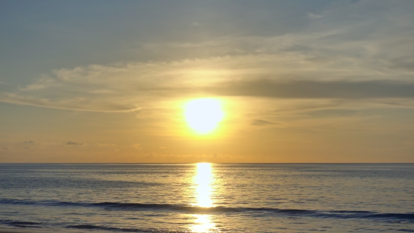 Sea at sunset or sunrise over beach video 4K, The sun touches horizon, Red sky in golden hour amazing seascape,Ocean beach sunsets,The sun in spindrift clouds Fantastic natural sunsets Royalty-Free Stock Footage #1092053553