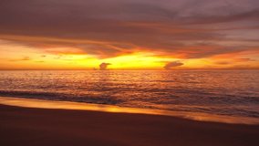 Sea at sunset or sunrise over beach video 4K, The sun touches horizon, Red sky in golden hour amazing seascape,Ocean beach sunsets,The sun in spindrift clouds Fantastic natural sunsets
