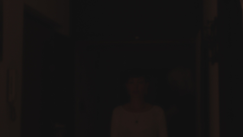 confident young woman approaches the camera and smiles