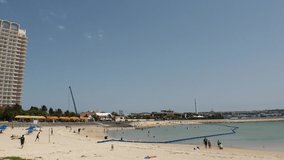 CHATAN-CHO, OKINAWA, JAPAN - AUGUST 2021 : View of Chatan sunset beach (Ocean or sea). Wide view, time lapse shot in daytime. Summer holiday, vacation and resort concept video.