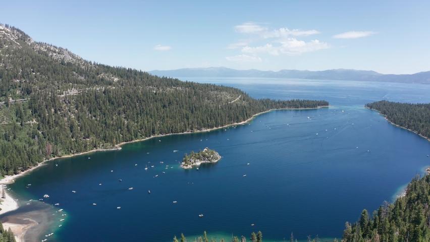 Wide panning aerial shot of Emerald Bay with boat traffic in Lake Tahoe. 4K