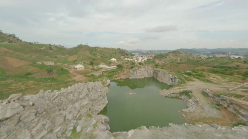 Beautiful still lake within a Quarry at Abuja, Nigeria by AVIS