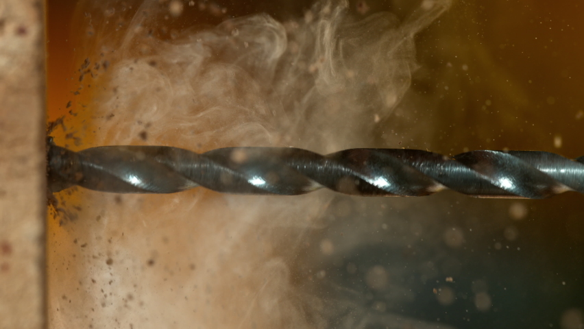 Super slow motion of a drill bit drilling into brick wall, macro. Filmed on high speed cinema camera, 1000 fps.
