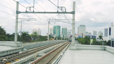 JAKARTA, INDONESIA - NOVEMBER 29, 2021: An MRT train enters ASEAN Station from the direction of Bundaran HI . station