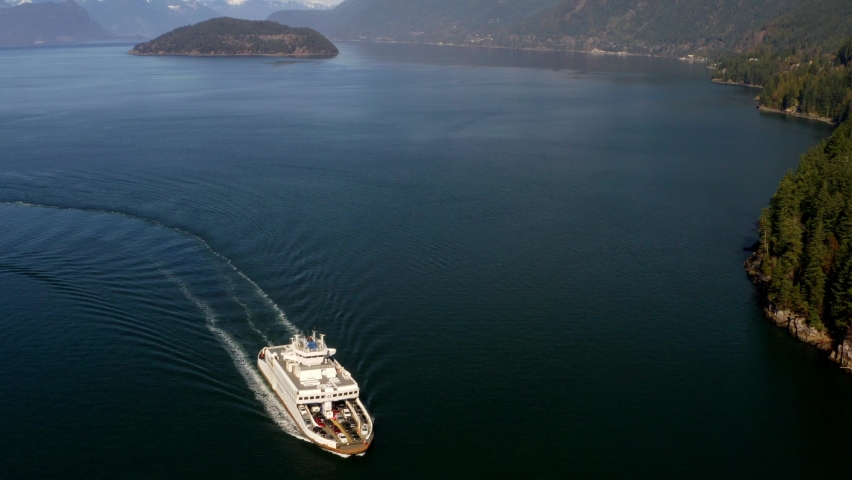 Drone View of Marine Vessel and Stunning Scenery of Sea to Sky Mountains and Ocean Natural Landscape. A Car Ferry Moves in the Blue Waters of Howe Sound near Vancouver in British Columbia Canada Royalty-Free Stock Footage #1092085045