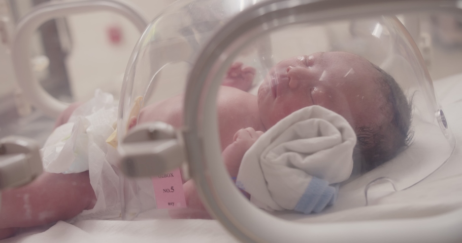 Closeup little newborn baby infant in incubators for newborns, Newborn baby having the the breathing problem after birth, newborn in NICU, Neonatal intensive care unit, healthcare Royalty-Free Stock Footage #1092086995