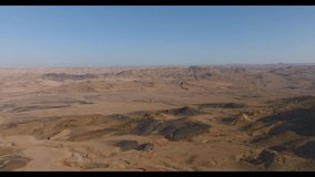 Drone Video of the Ramon Crater (Israel Desert) During Sunset. With rare rock formations and distinct rock colors.