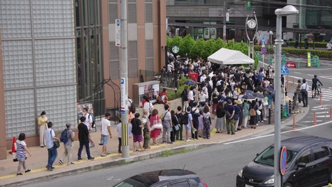 Nara, Japan - July 9 2022: Hundreds of Japanese People Line up to Pay Respects at Site of Shizo Abe's Assassination the day after