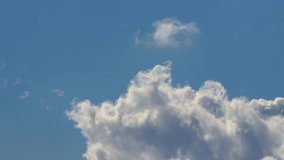 4k timelapse of cumulus clouds puffing up and dancing in a blue sky