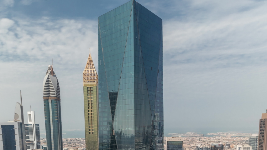 Panorama of futuristic skyscrapers in financial district business center in Dubai on Sheikh Zayed road during all day timelapse with shadows moving fast. Aerial view from above