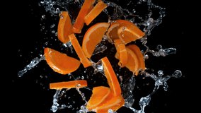 Super slow motion shot of rotating exploded orange slices with splashing water on black at 1000fps. - Powered by Shutterstock - Get 15% off with code: PIKWIZARD15