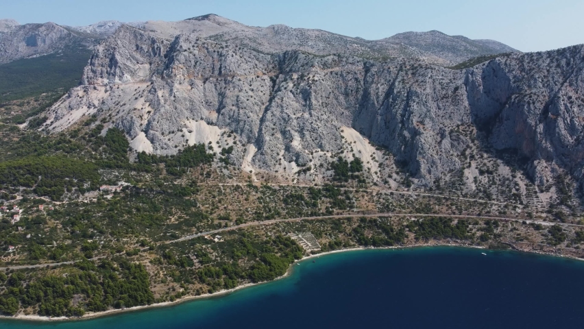 Coastline of Croatia with turquoise water, near the city of Makarska. Aerial view of Adriatic sea and epic mountains. Adriatic coast aerial view in high quality 4k. Royalty-Free Stock Footage #1092106581