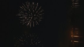 Vertical 4k footage of beautiful Fireworks on Deep Black Background Sky on Fireworks festival from sail yacht over night city lights in summer river night trip. High quality 4k raw video - Powered by Shutterstock - Get 15% off with code: PIKWIZARD15
