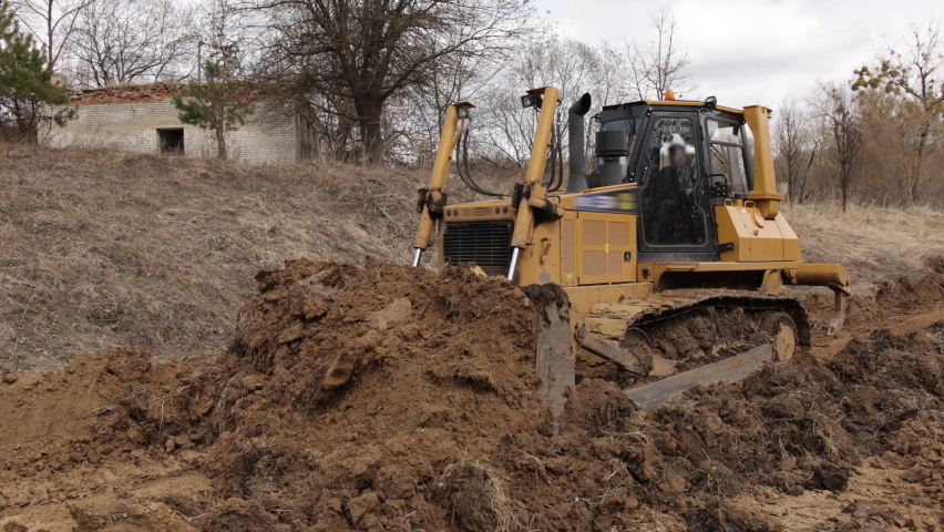 Heavy backhoe construction machinery equipment concept. Earth mover, bulldozer. Big yellow front-end loader, all-wheel bulldozer. Heavy machinery machine, manufacturing equipment for open-pit mining.