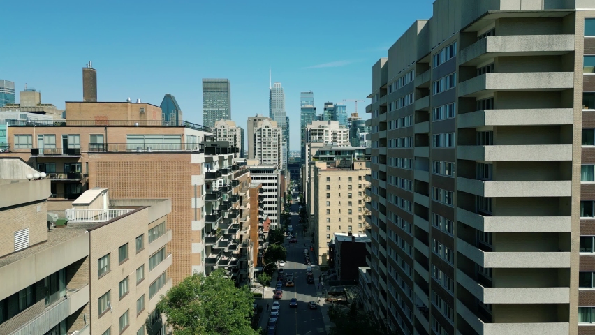 4K Cinematic urban drone footage of an aerial view of buildings and skyscrapers in the middle of downtown Montreal, Quebec on a sunny day.
