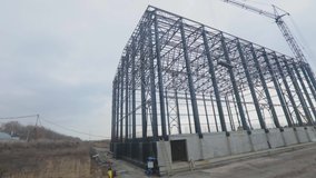 Construction of a large warehouse for a factory. Industrial exterior. Large steel structure building. Metal frame of an industrial building. Construction of an industrial building. - Powered by Shutterstock - Get 15% off with code: PIKWIZARD15