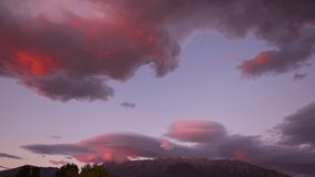 Lenticular clouds in real time moving during colorful sunset over mountain in Utah. - Powered by Shutterstock - Get 15% off with code: PIKWIZARD15