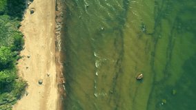 Top down video of Baltic sea and shoreline. Aerial view of beautiful beach and baltic sea. Drone video close up