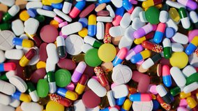 Countless multi-colored pills, capsules and tablets  Seamless looping video with colorful drugs. Perfect background for medicine, pharmacy or healthcare topics.
