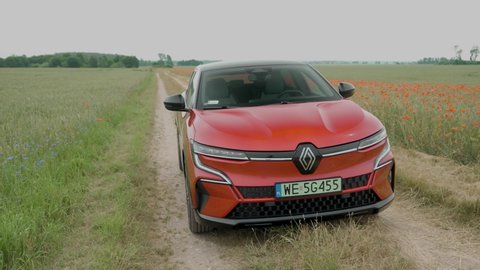 Riga, Latvia 11 July 2022, Renault Megane E-Tech Electric is a battery electric-powered small family car. Stands on road at background landscape puppy field countryside mood.