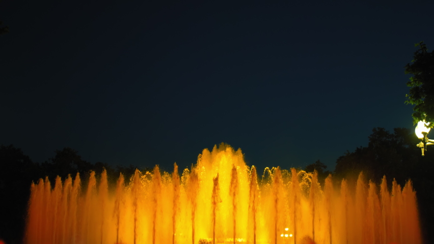 Magic singing magic fountains of Montjuic, people watch the performance that takes place several times a week