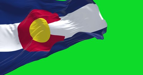 the flag of the US state of Colorado waving in the wind isolated on a green background. Colorado is a state in the Mountain West subregion of the Western United States. Seamless loop in slow motion