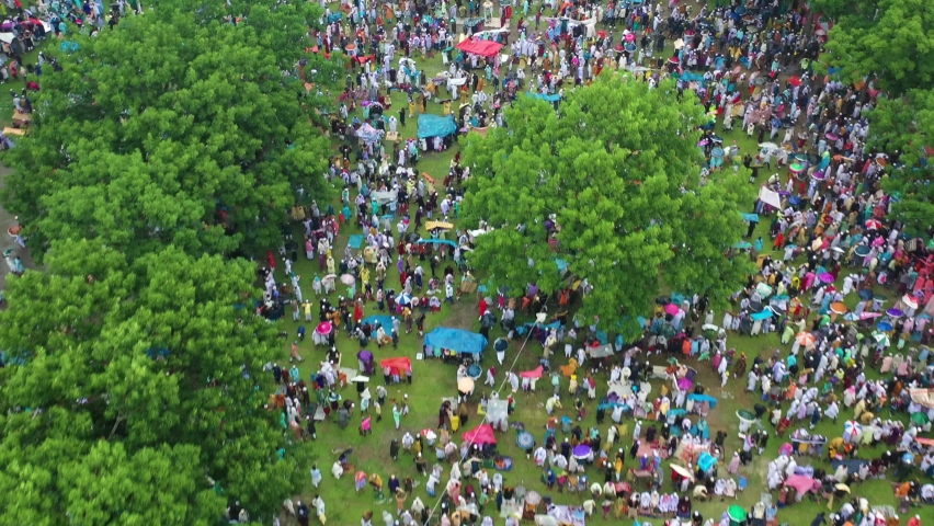Aerial view of People Worshipping at Eid-ul-Fitr, Mubarak outdoors, Kishoreganj, Dhaka, Bangladesh. Royalty-Free Stock Footage #1092135183