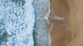 Aerial video beautiful closeup shot beach and seawater on wave on sand in sunset time (Top-view) nature and travel concept video.