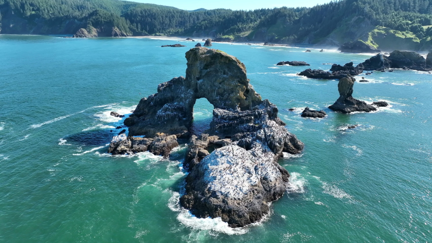 Surrounded by ocean, rugged sea stacks lie just off the Northern Oregon shoreline, not far west of Portland. This part of the Pacific Northwest is full of scenic forests and impressive coastlines. Royalty-Free Stock Footage #1092137157