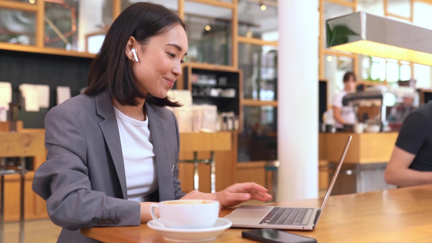 Busy young Asian business woman talking with partner via video call virtual meeting, giving presentation to remote client or having job interview videocall distance working online on laptop computer. Royalty-Free Stock Footage #1092140691