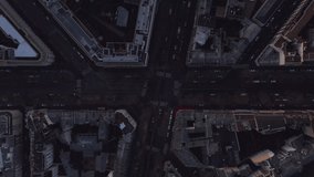 Top down footage of buildings and streets in city. Poorly illuminated town borough at dusk. Paris, France