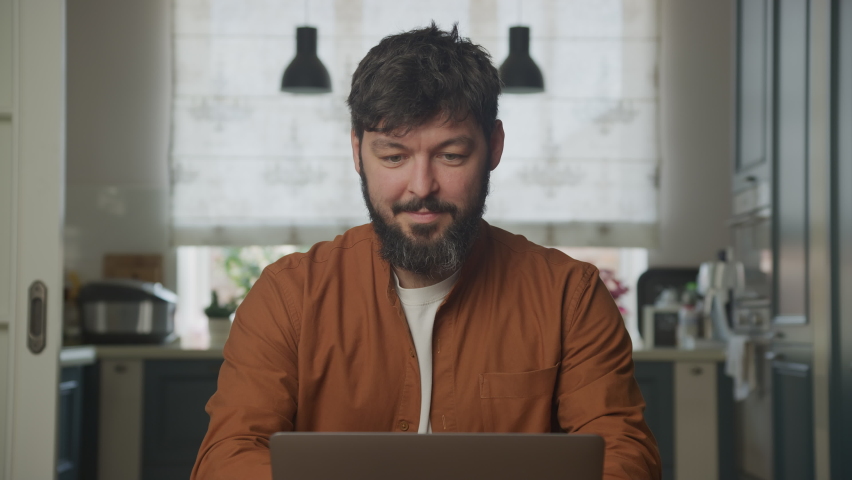 Happy young adult studying on a computer laptop 