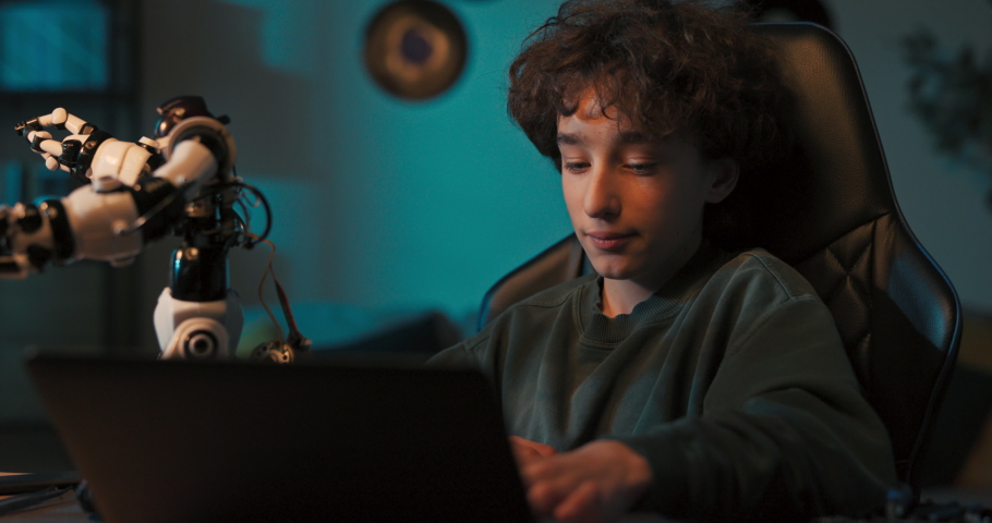 Shocked, the boy programmed the robot using his laptop, the toy came to life began to go crazy. The child was surprised, excited, applauding and happy.