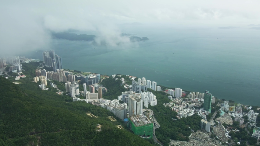 Drone flying forwards revealing Aberdeen City in Hong Kong, flying over the cloud.