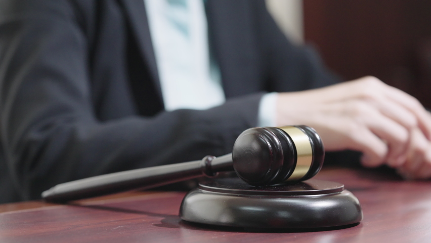 Slow motion Judge's hand with wooden gavel hitting Gavel in courtroom | Shutterstock HD Video #1092156243
