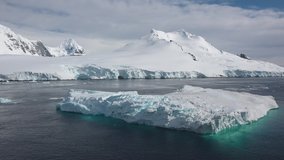 Global warming. Climate change. Warming temperatures gradually melt glaciers with Global climate warming. Antarctica Melting Blue Water Iceberg. Antarctic Ocean Environment. - Powered by Shutterstock - Get 15% off with code: PIKWIZARD15