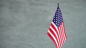 State flag of United States of America waving on light background. American flag and place for text