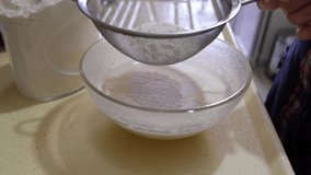 Sifting and adding flour to the cake mixture