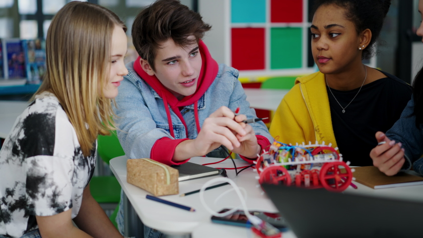 Group of high school students building and programming electric toys and robots at robotics classroom Royalty-Free Stock Footage #1092175409